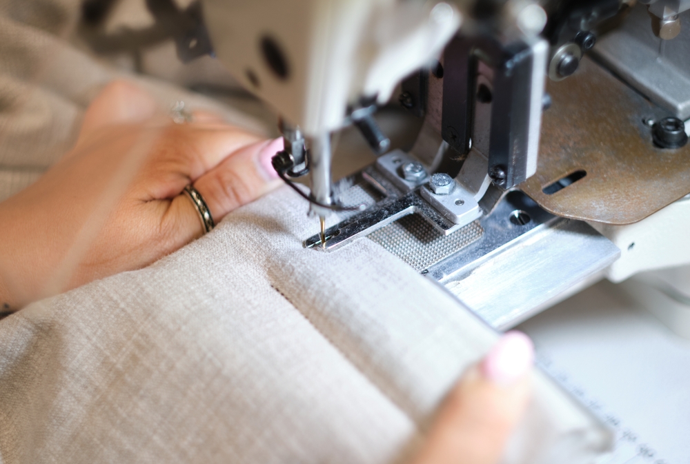 Hands,On,A,Sewing,Machine,Working,In,A,Textile,Factory